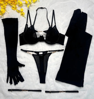 Flat lay of the black set: bra, thong, gloves, stockings and two leg bands