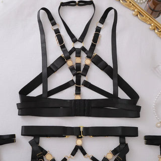 Close view of the black cage top with its gold rings and pearls
