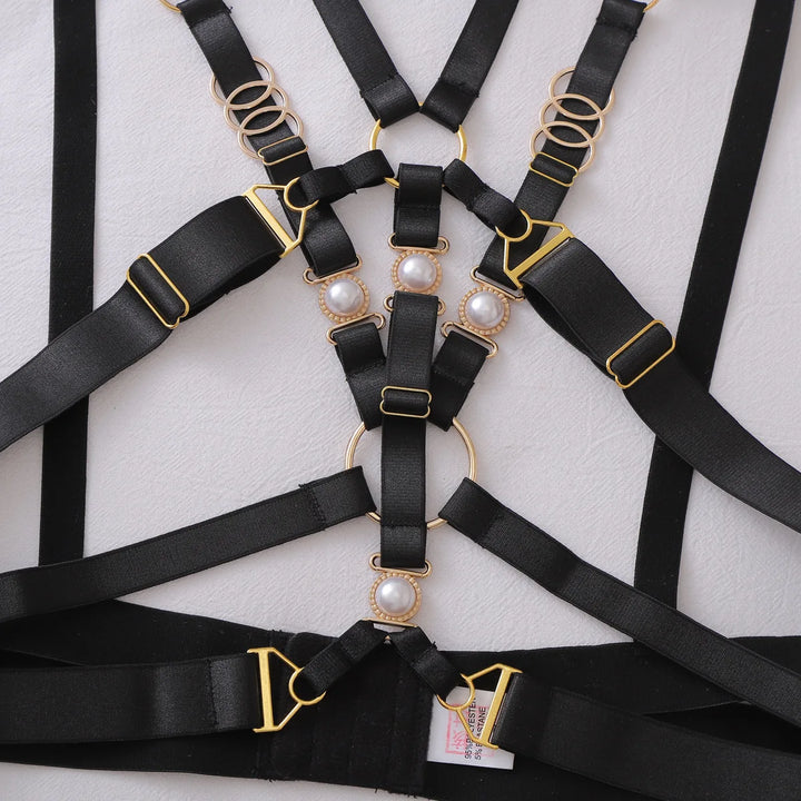 Close view of the pearl and gold-tone fittings on the black straps