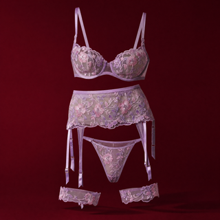 Amara lilac embroidered lingerie set on a burgundy studio background