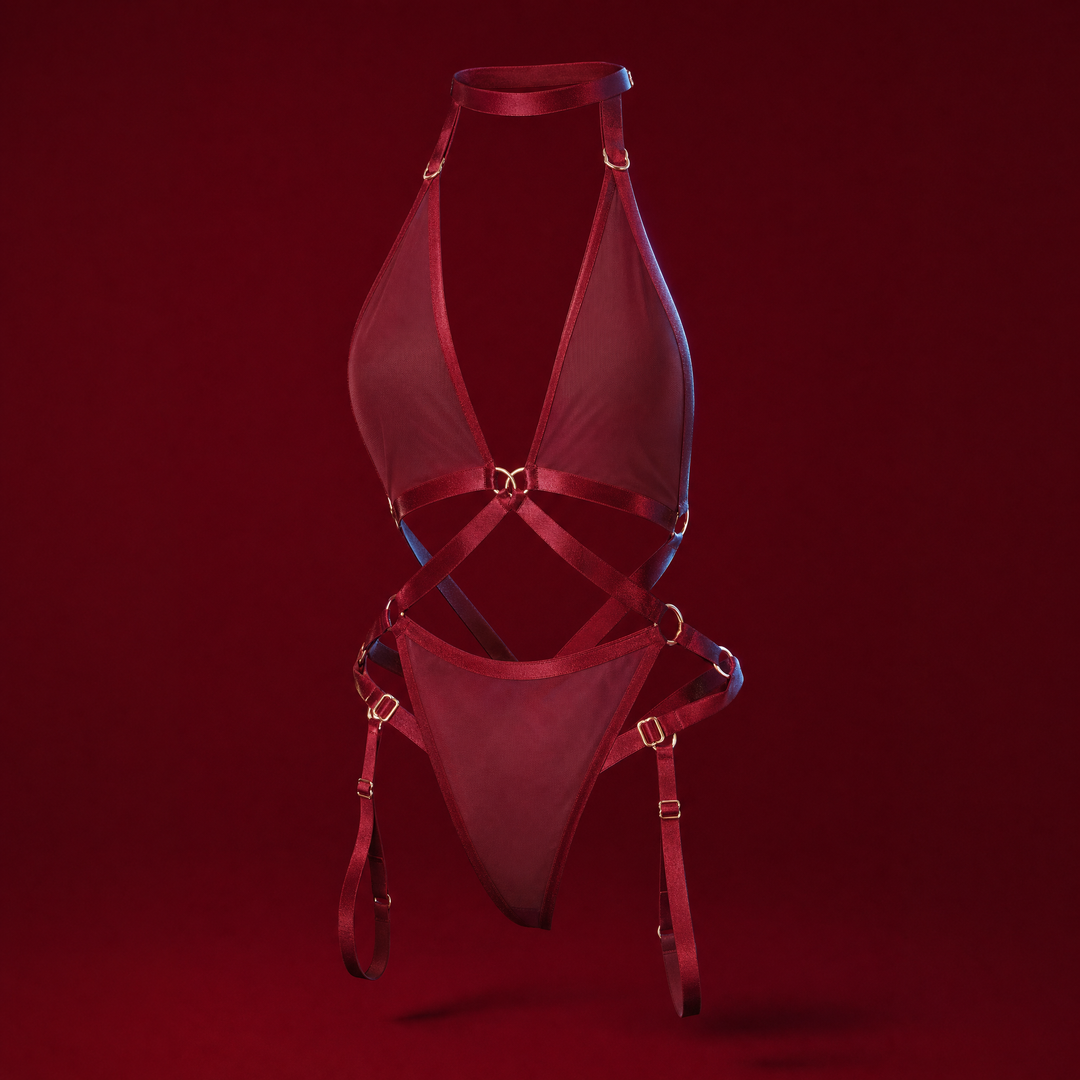 Iris burgundy strappy mesh bodysuit on a burgundy studio background